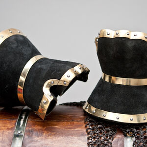 Gauntlets are decorated with brass trimming and covered with black split leather