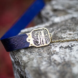 “Townswoman” embossed leather belt with "Keys and Symbols" letters