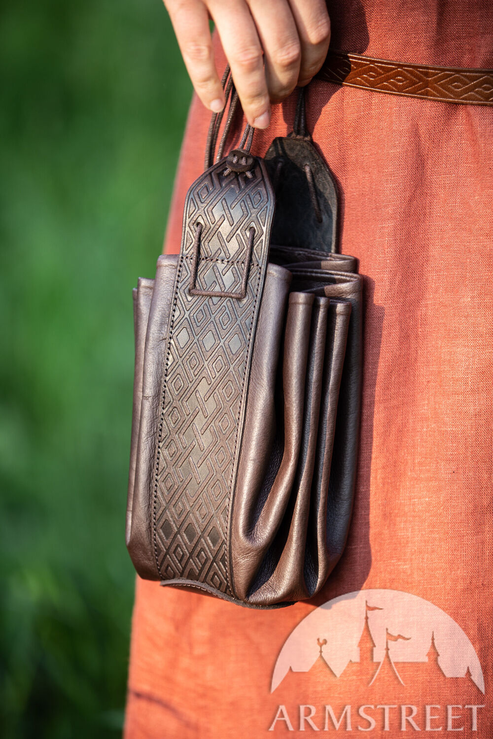 Round embossed leather bag “Fireside Family”