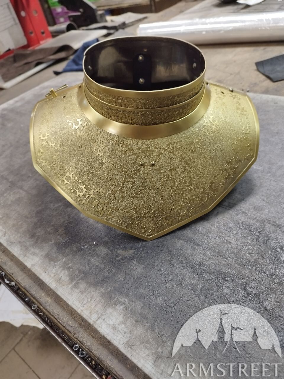 Etched stainless steel armor with a golden finish